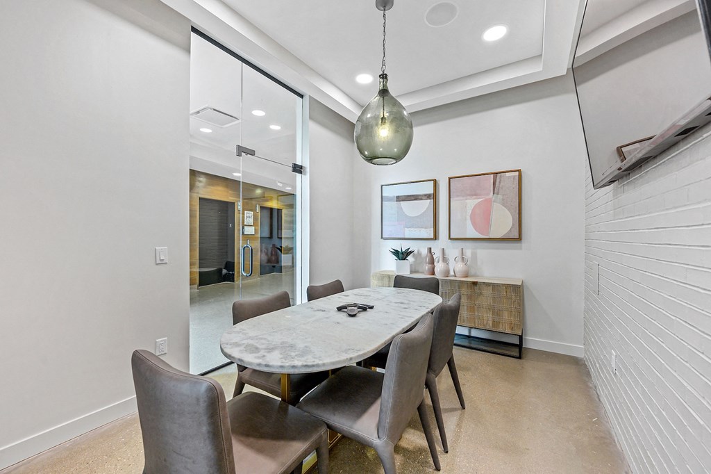 Dog-Friendly Apartments in West Chester, OH - Liberty Center - Conference Room with Quartz Table, Glass Doors, and a Mounted Television