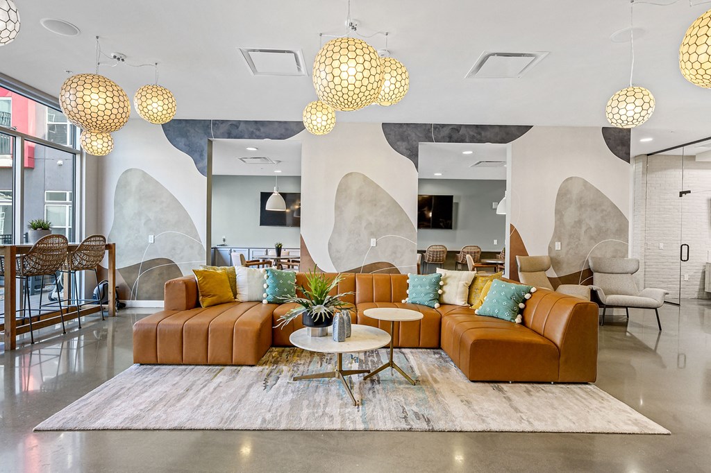 a living room with couches and chairs and a rug