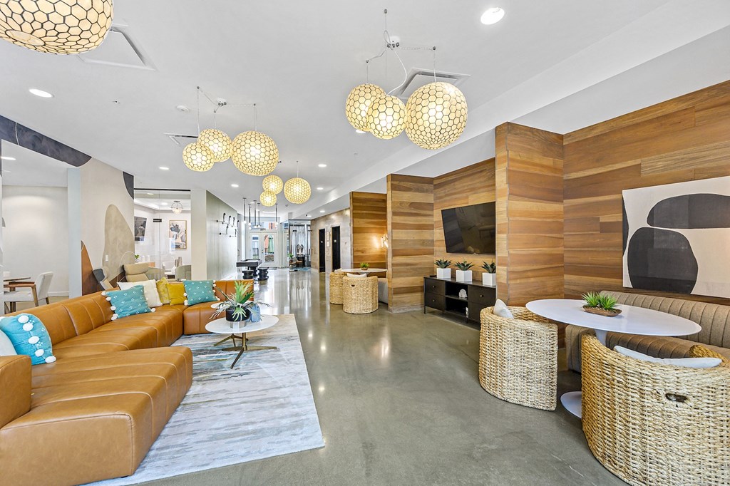 the lobby of a hotel with couches and tables