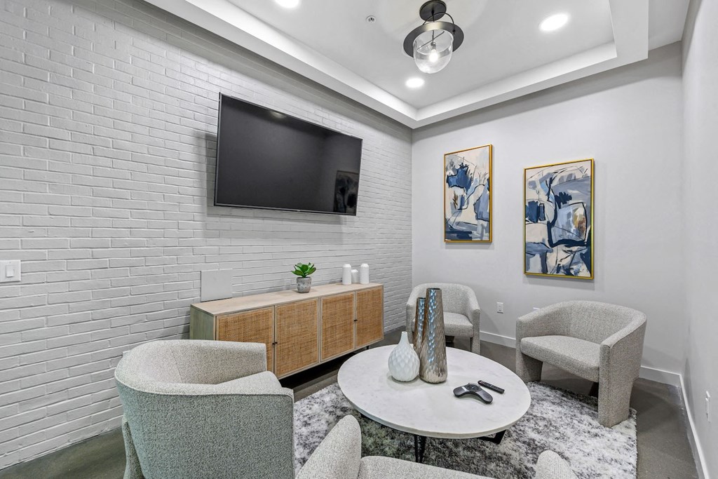 a living room with a table and chairs and a television