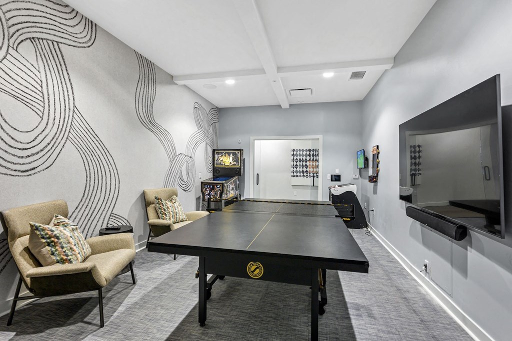 Dog-Friendly Apartments in West Chester, OH- Liberty Center- Gameroom with Ping Pong Tabe, Arcade Games and Grey Carpeting