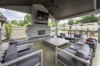 the outdoor patio has a fireplace and couches and tables at Olde Towne in Kenwood, Ohio, 45243