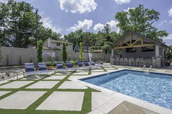 a swimming pool in front of a house with lounge chairs at Olde Towne in Kenwood, Cincinnati, 45243