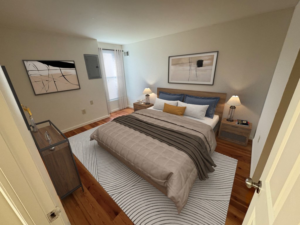 A bedroom with a bed, nightstands, and a painting on the wall.