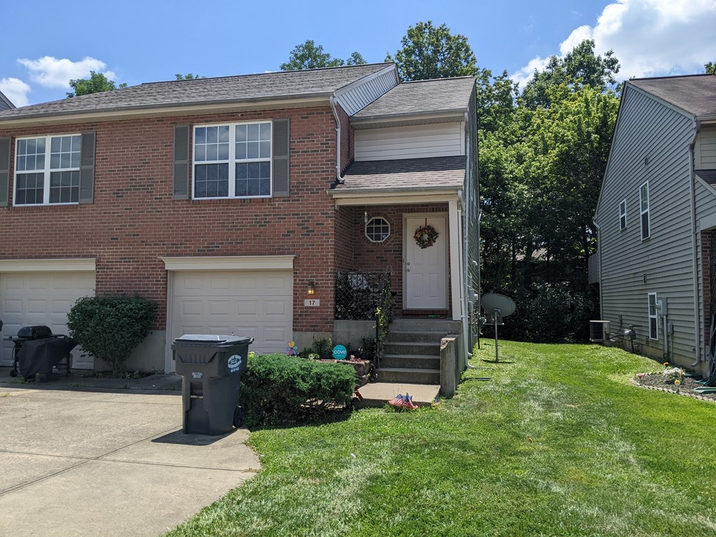 a house with a garbage can in front of it