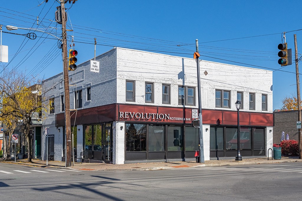 a building on the corner of an intersection with a traffic light