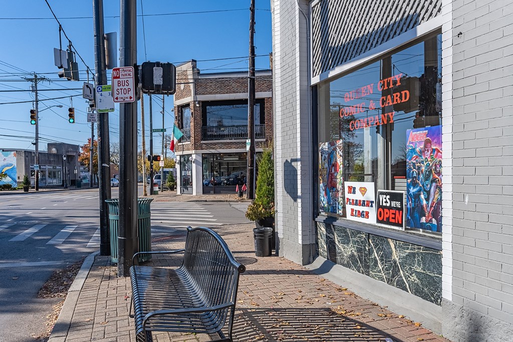 a bench in front of a store on a city street