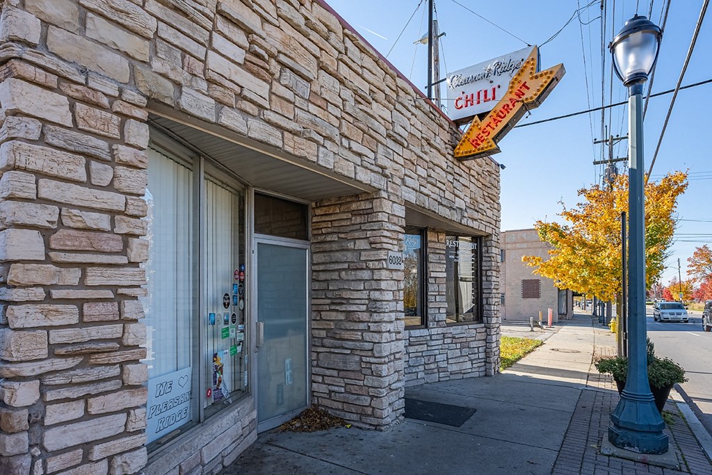 a brick building with a sign for a chili restaurant