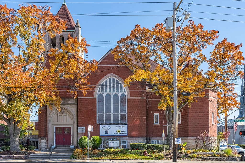 an old church with orange trees in front of it