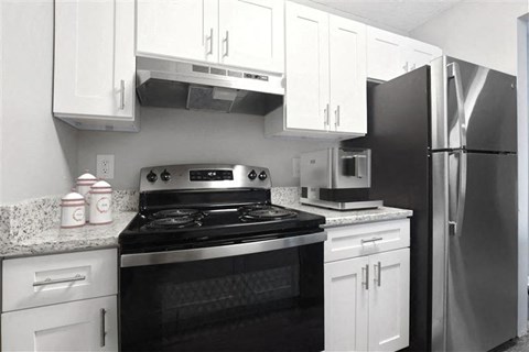 A kitchen with white cabinets and a black stove top at Parkview of Lebanon Apartments, Lebanon, IN, 41042