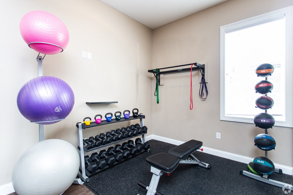 an exercise room with weights and balls and a window at Prescott Place, Ohio