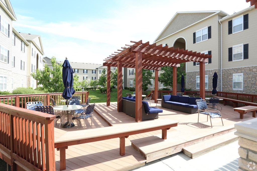 a patio with a wooden pergola and furniture at Prescott Place, Columbus, OH, 43235