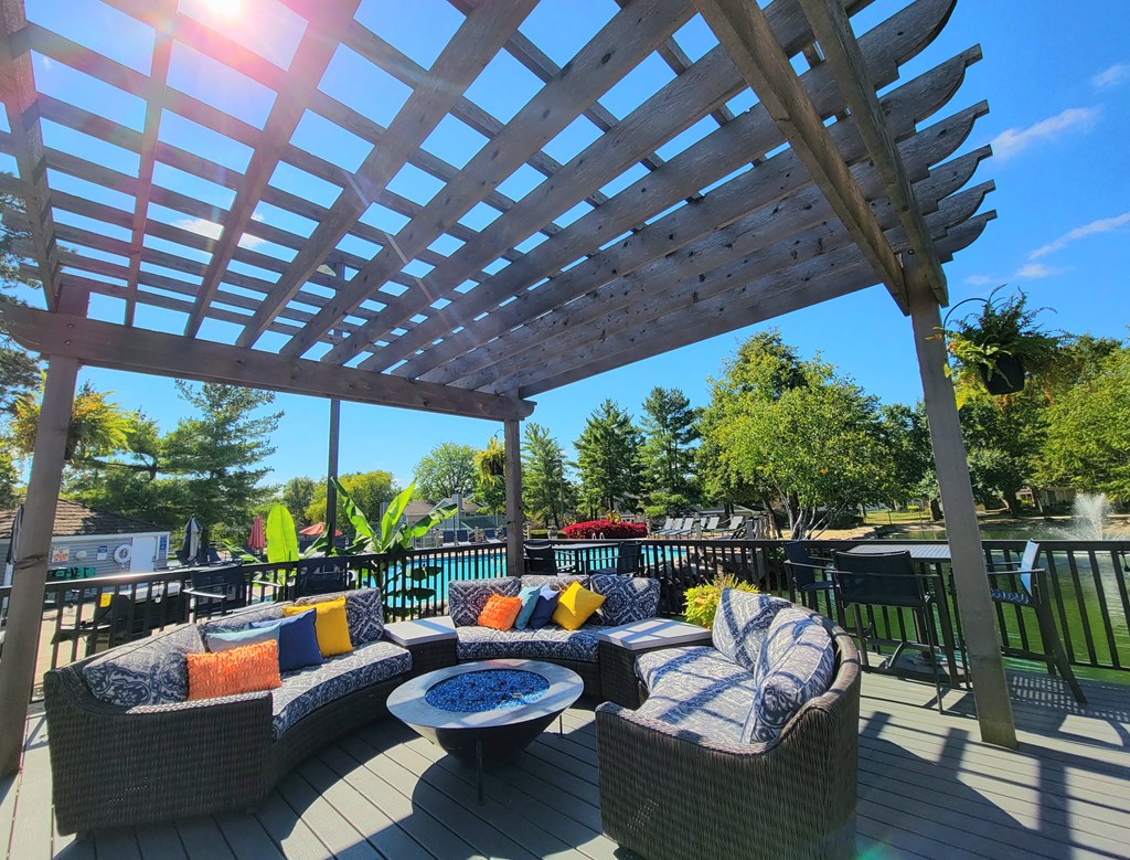 a pergola on a deck with couches and a table at Harpers Point Apartments, Cincinnati, 45249
