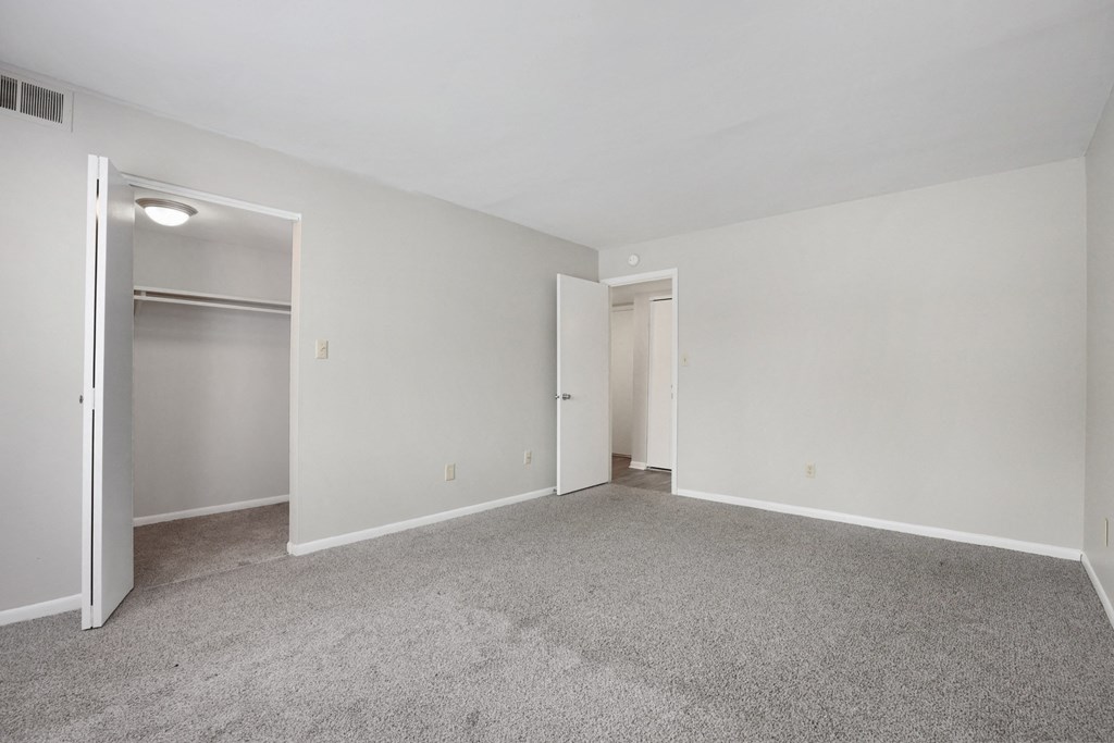 A room with a grey carpet and white walls.