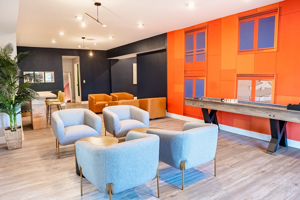 a room with blue chairs and orange walls