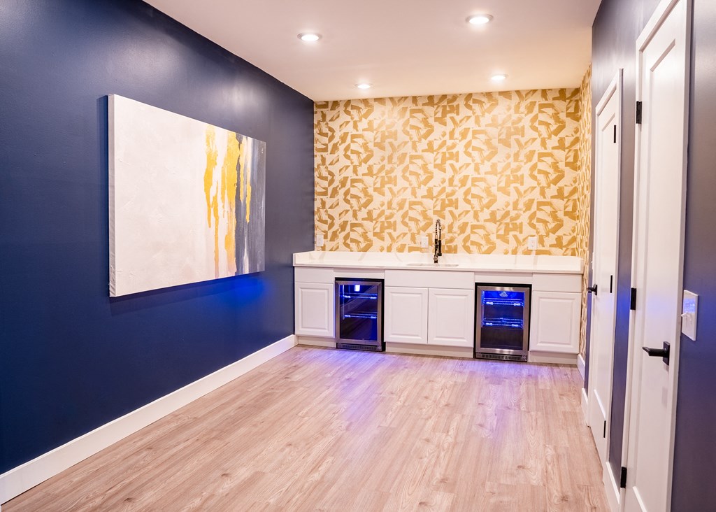 a kitchen with blue walls and white cabinets
