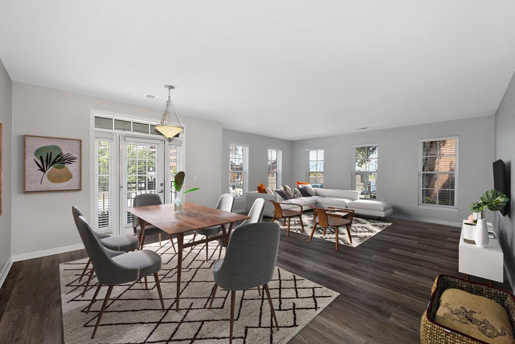 a living room and dining room with a table and chairs