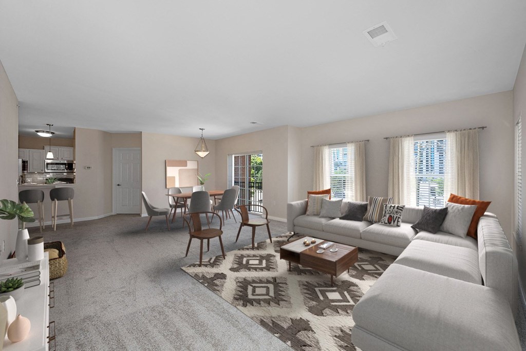 a living room with a couch and a table with chairs