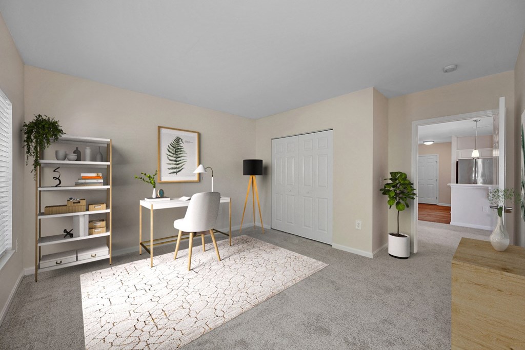 an office with a desk and a rug in a living room