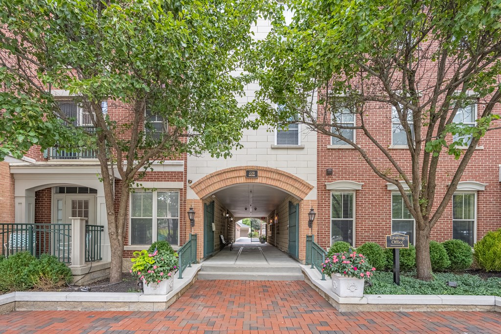 a view of a building with a long hallway with trees