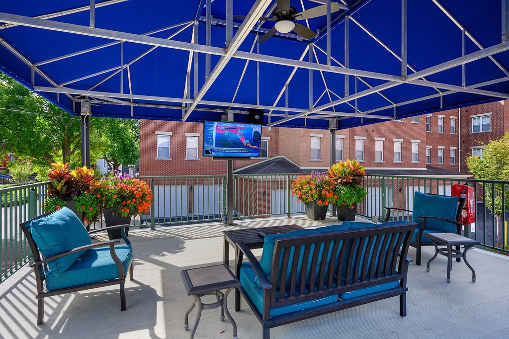 our patio with chairs and a table and a tv