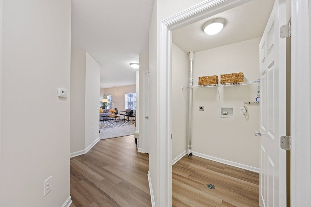 a hallway with hardwood floors and white walls