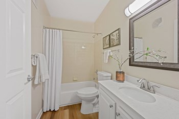 a bathroom with a white sink and toilet and a white shower curtain - Photo Gallery 51