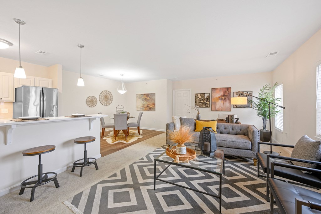 a spacious living room with a kitchenette and dining area