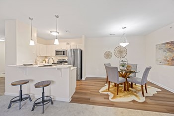 a kitchen and dining room in a 555 waverly unit - Photo Gallery 37