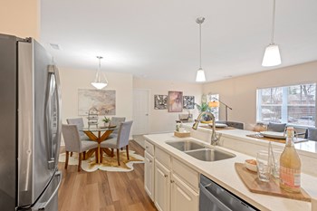 a kitchen and dining area in a 555 waverly unit - Photo Gallery 35