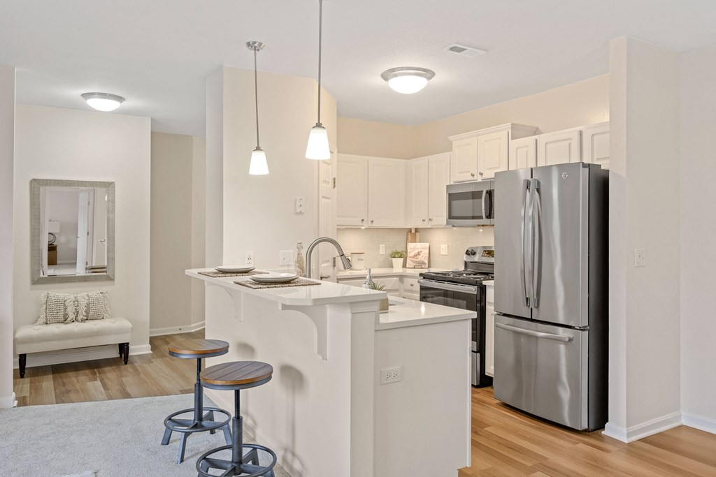 a kitchen with an island and two stools