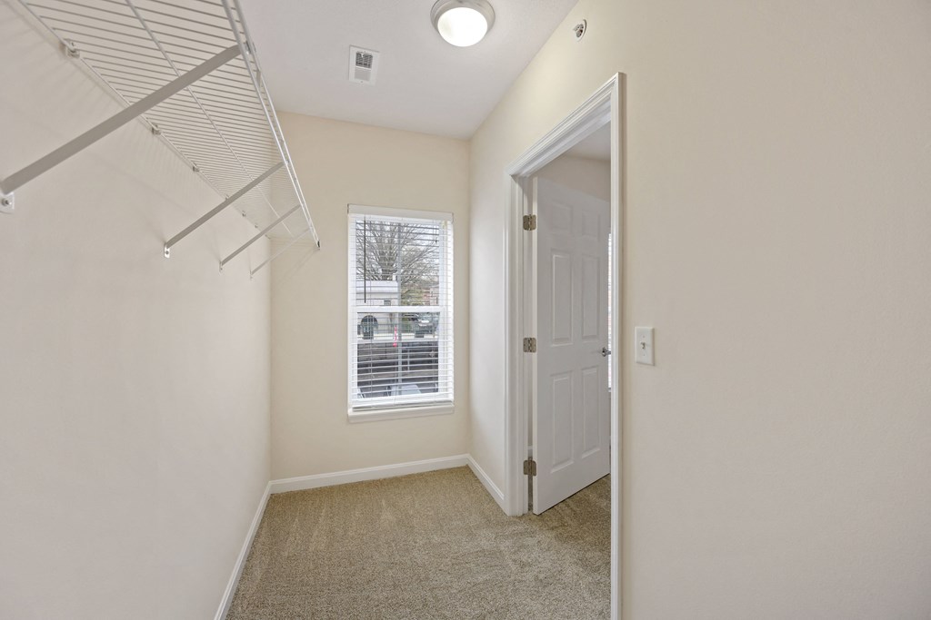 a bedroom with a closet and a window