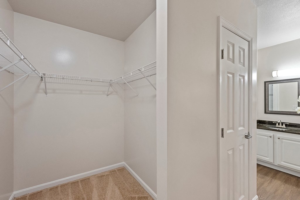 an empty bedroom with a closet and a bathroom