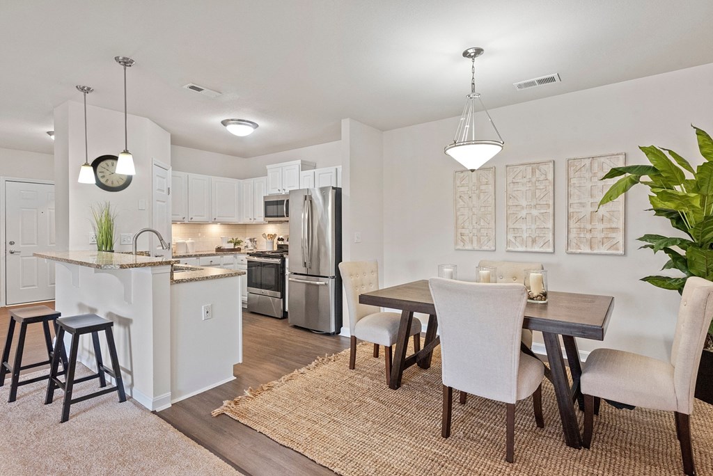 an open kitchen and dining room with a table and chairs