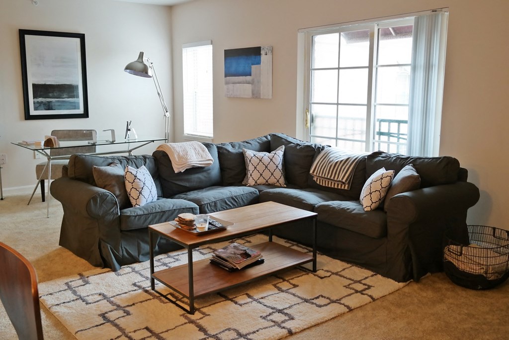 a living room with a leather couch and a coffee table