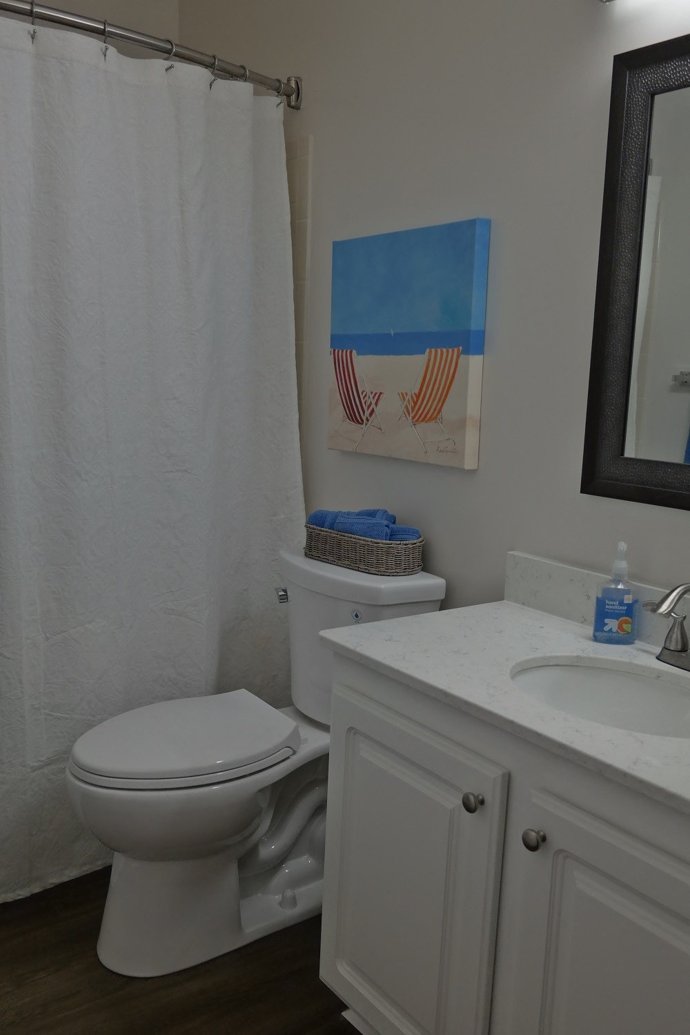 a bathroom with a toilet and a sink and a shower curtain