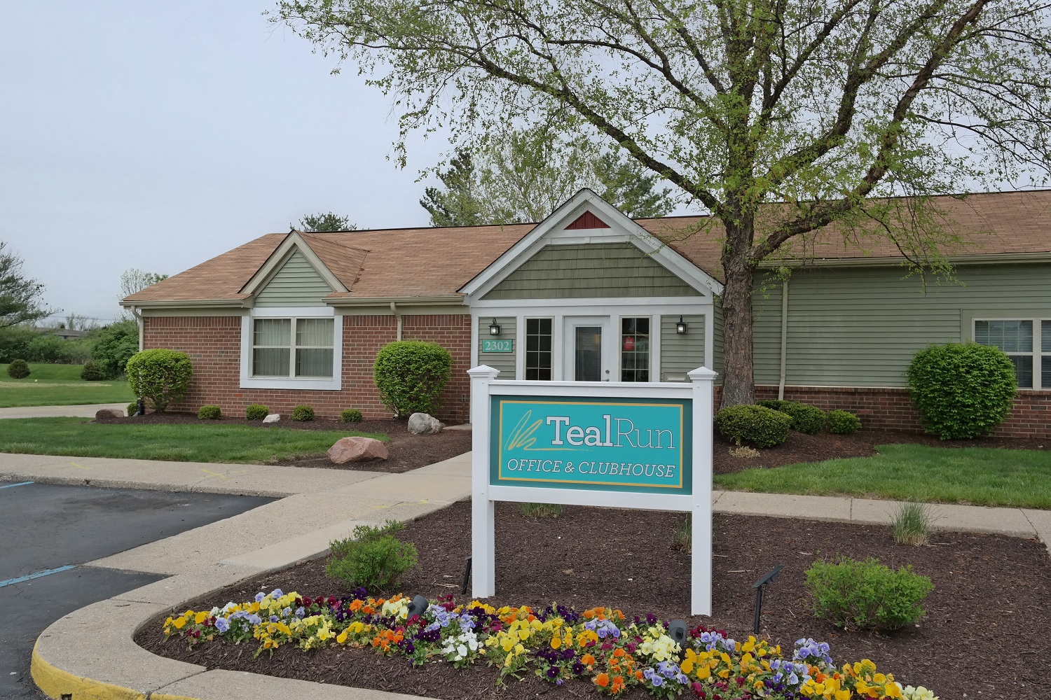 a house with a teal fun sign in front of it