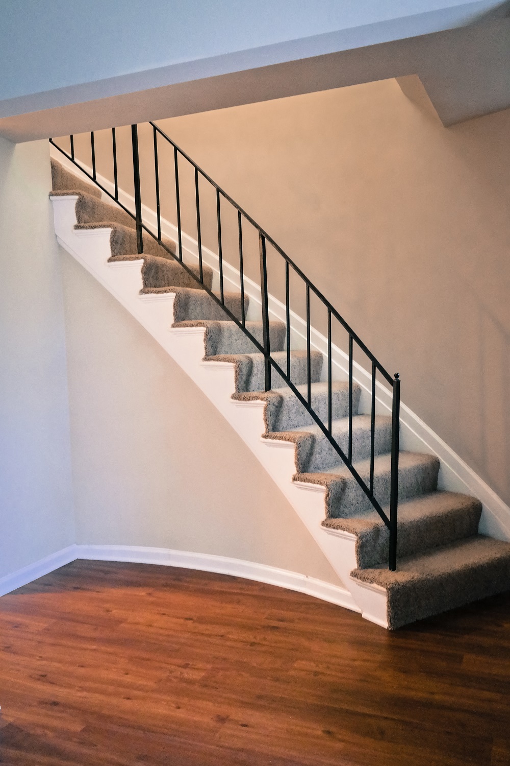 a set of stairs with carpet and railings in a home