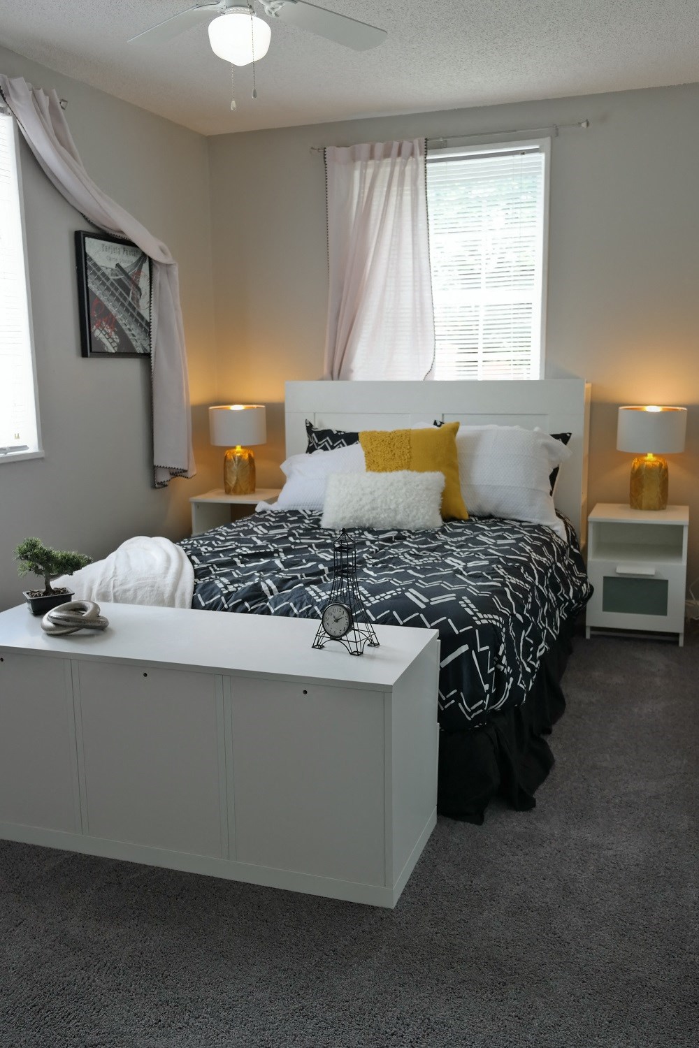 a bedroom with a bed and a nightstand and a window