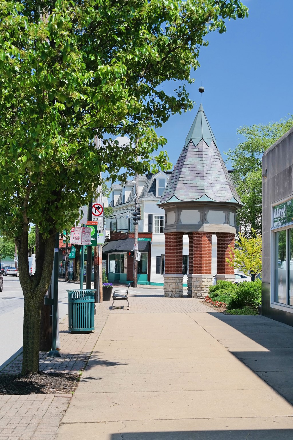 a small tower on the corner of a city street