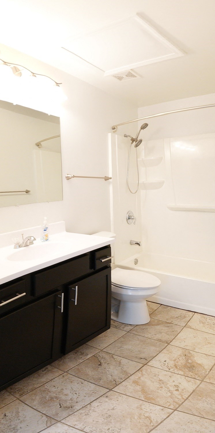 a bathroom with a toilet and a sink and a shower