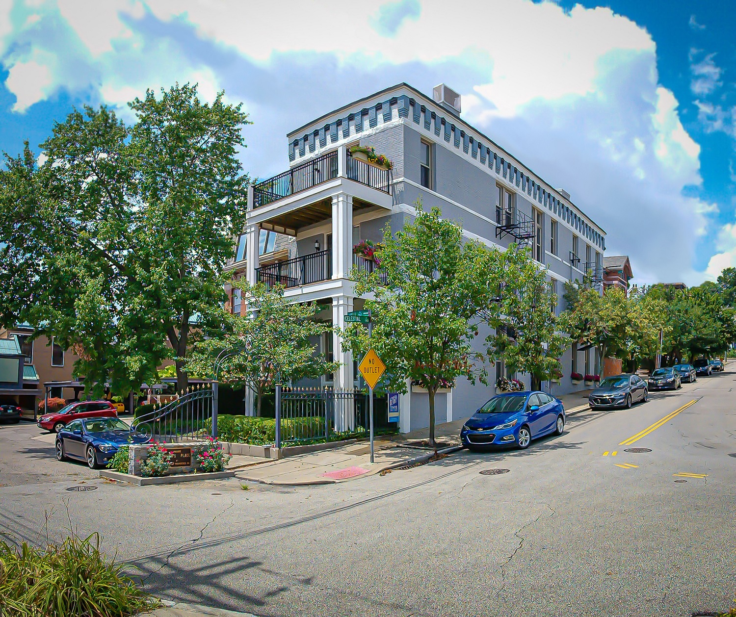 a building on the corner of a street with cars