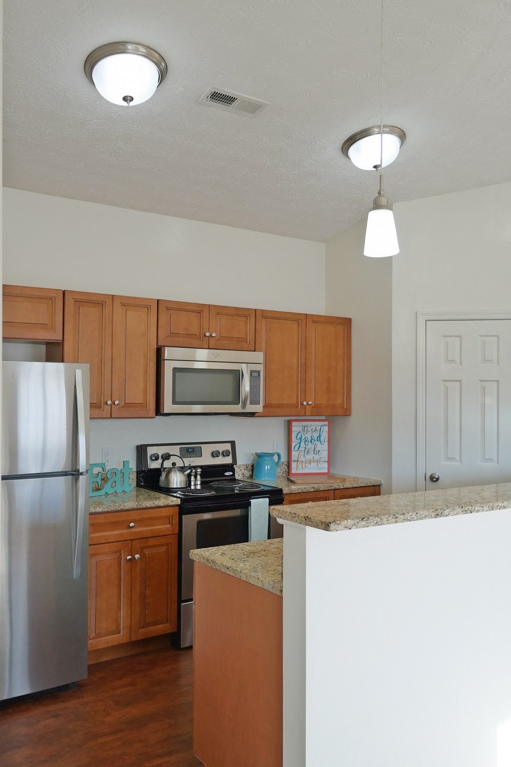a kitchen with wooden cabinets and stainless steel appliances