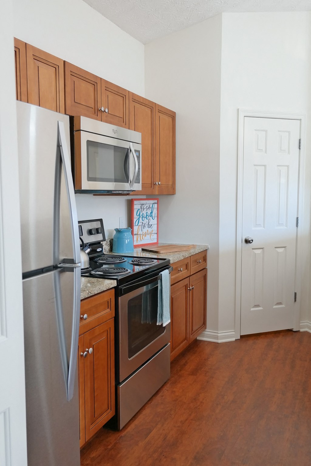 a kitchen with stainless steel appliances and wooden cabinets