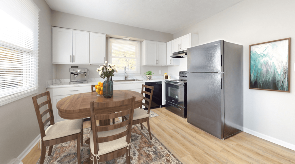 a kitchen with a table and a refrigerator at Stonebrook of Franklin, Franklin, IN, 46131