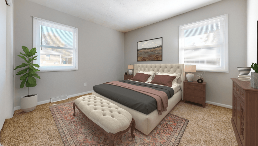 a bedroom with a bed and two windows at Stonebrook of Franklin, Franklin, 46131