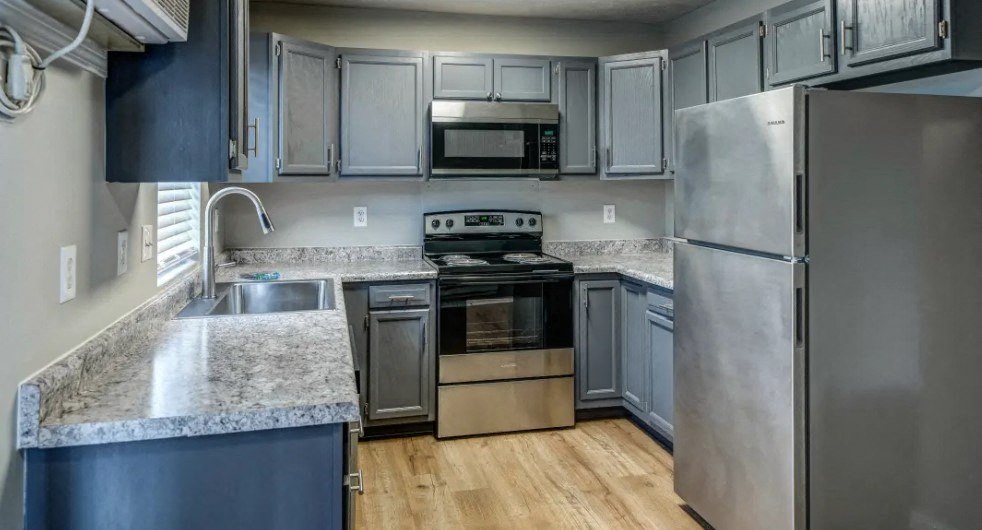a kitchen with gray cabinets and a stainless steel refrigerator at Ridgeview, Fortville, 46040