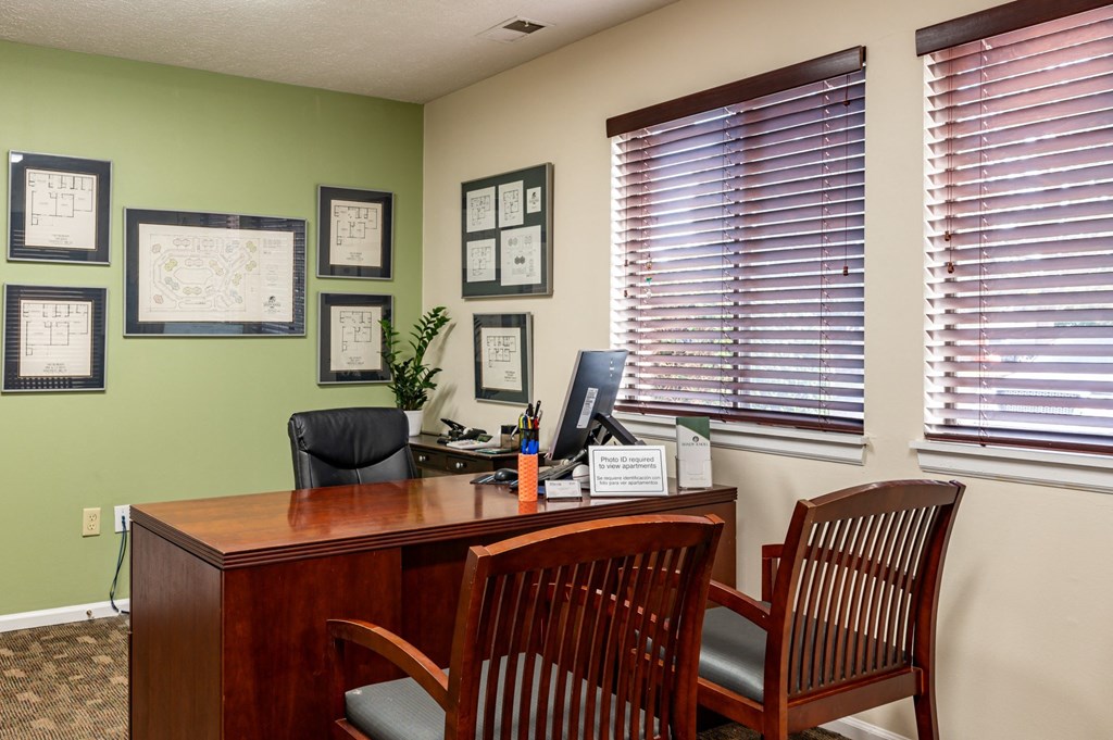 an office with a desk and chairs and a computer