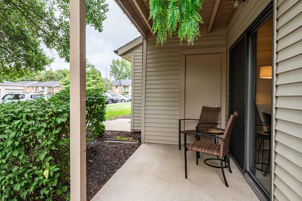 a porch with a chair and a table on it