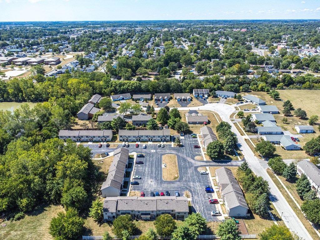 A large building complex with a parking lot in front.